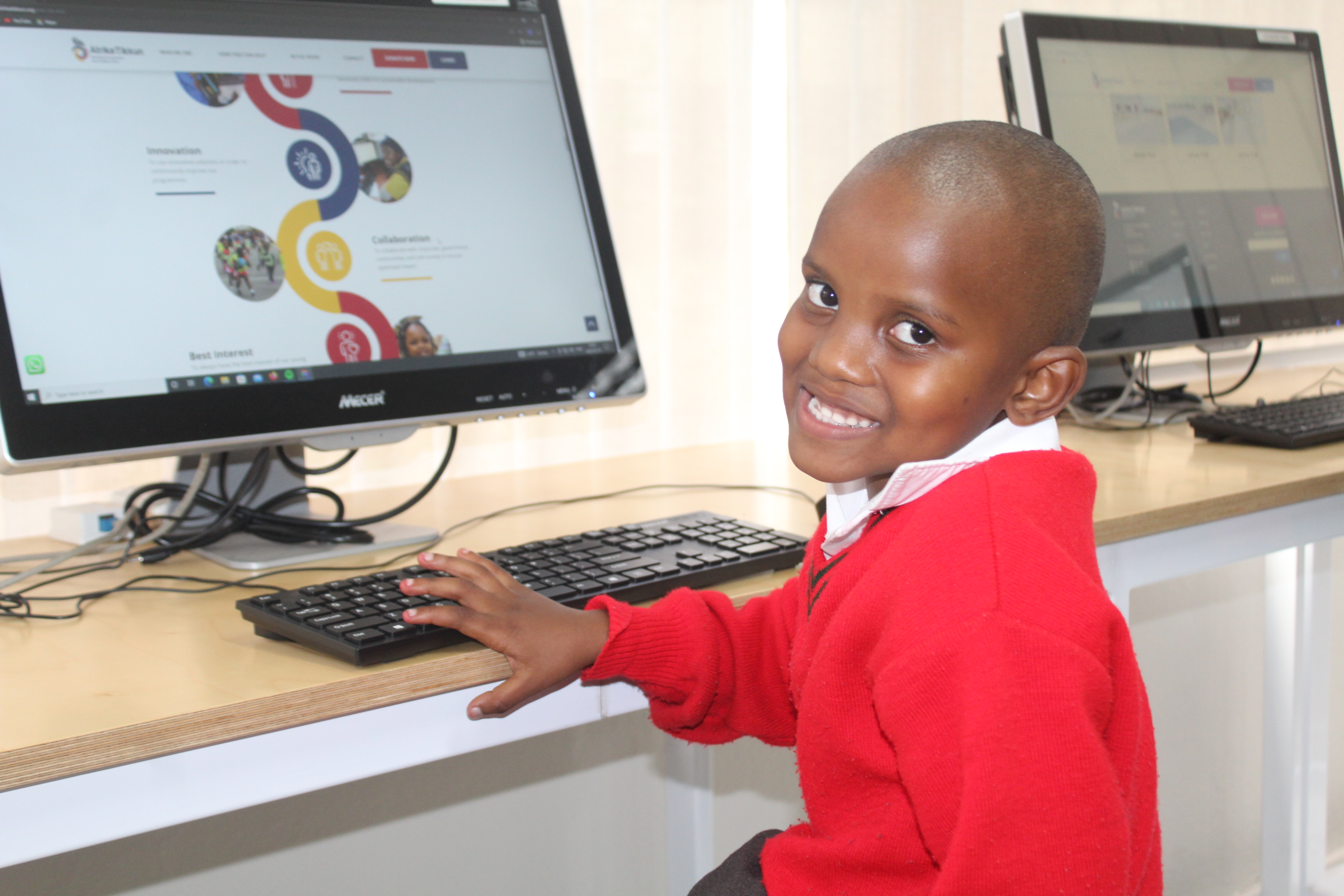 Learners working on computers in an Afrika Tikkun Ignite session